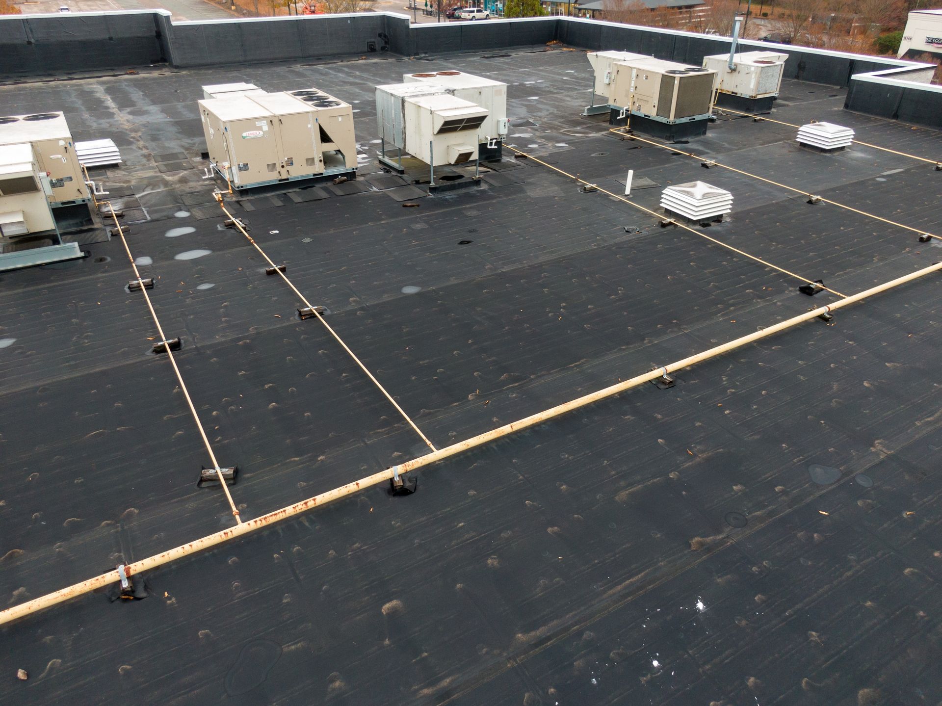 Black rooftop with HVAC units and lightning protection system.