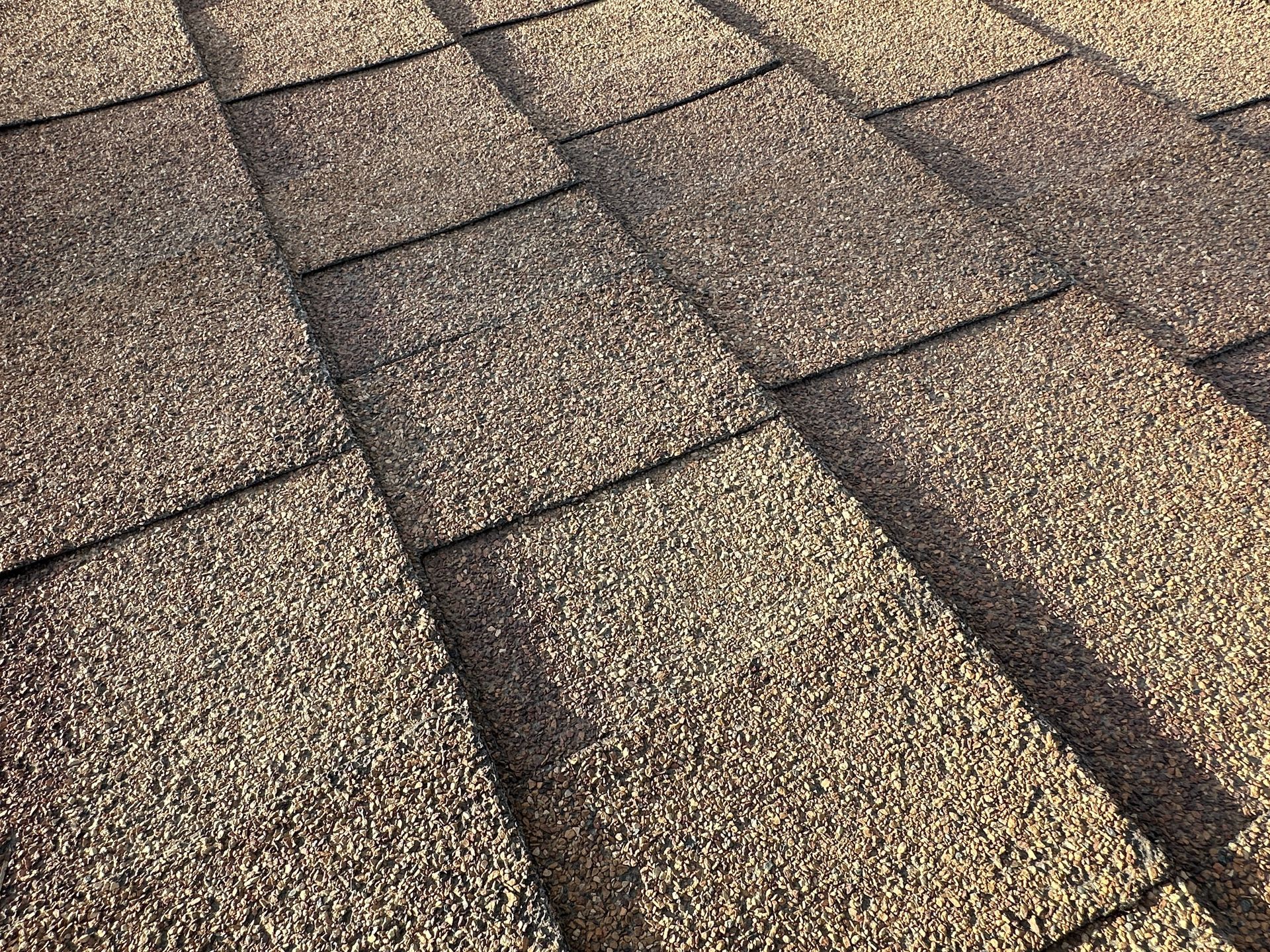 Close-up of brown asphalt roof shingles.