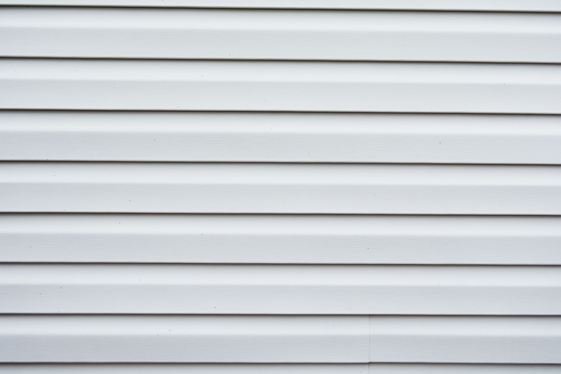 White horizontal siding on a building, evenly spaced.