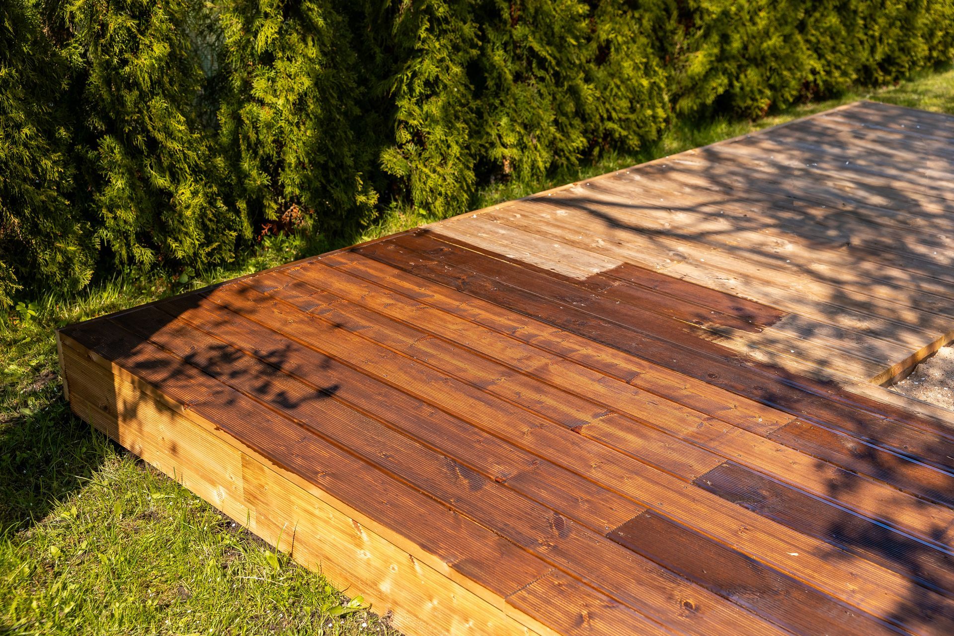Backyard deck with dark-stained wood.