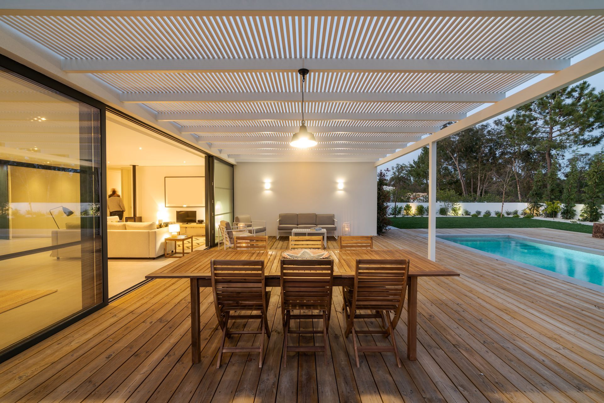 Covered patio with dining area and pool.