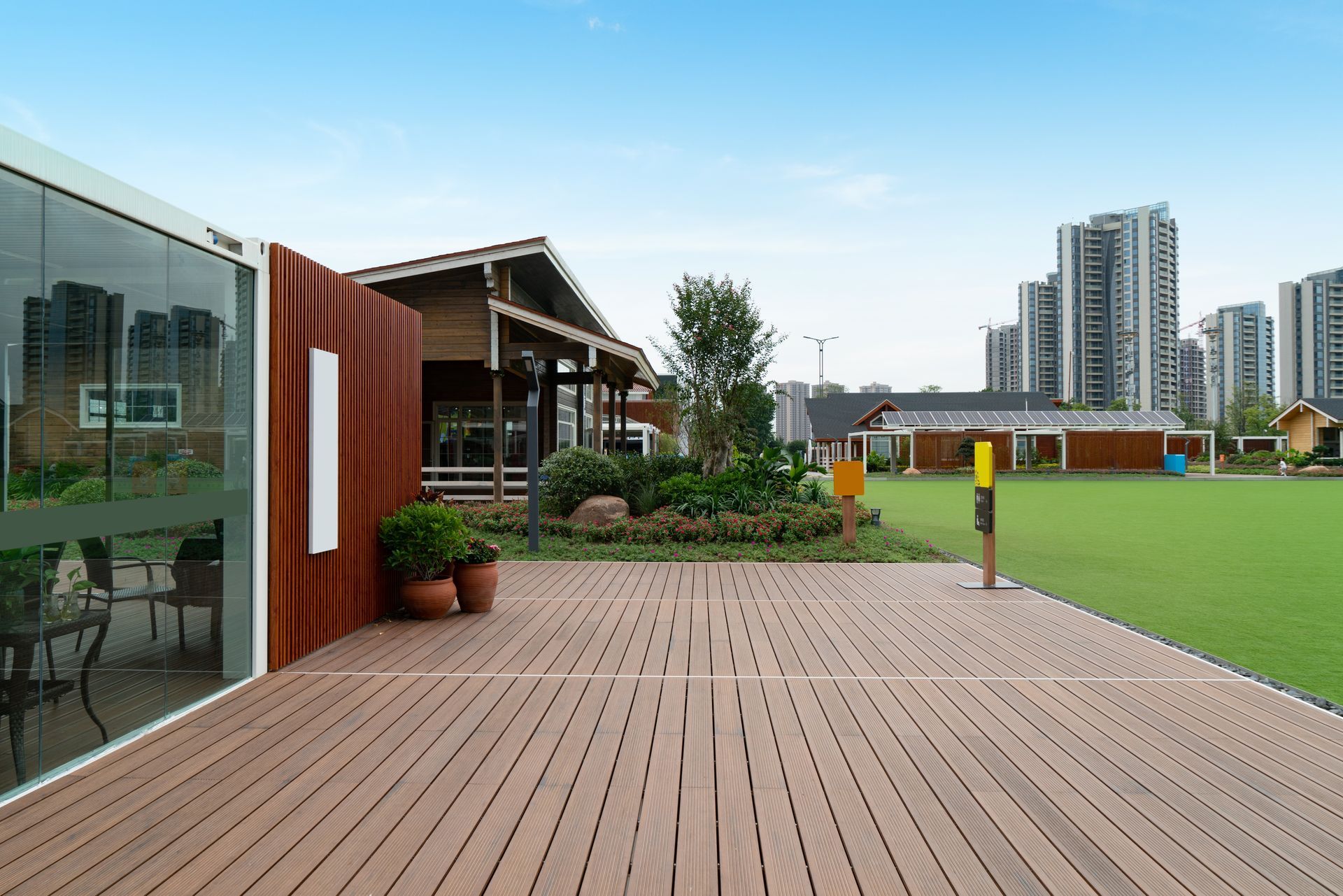 Modern patio and garden with city skyline.