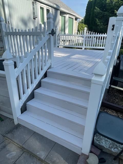 a wooden deck with a brick building in the background .