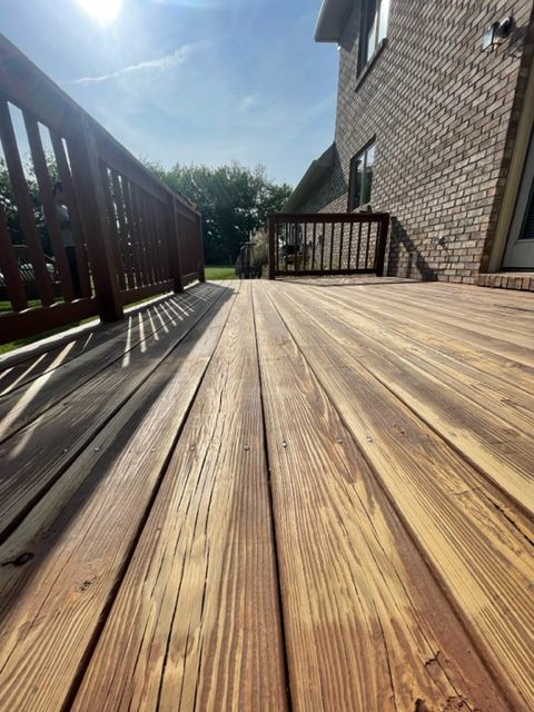 a wooden deck with a brick building in the background .