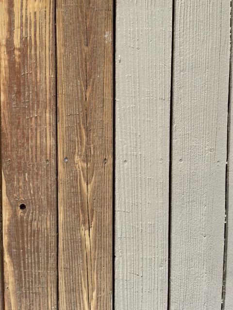 a wooden deck with stairs leading up to a brick house .