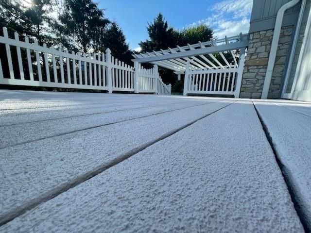 a large wooden deck is sitting in front of a house .
