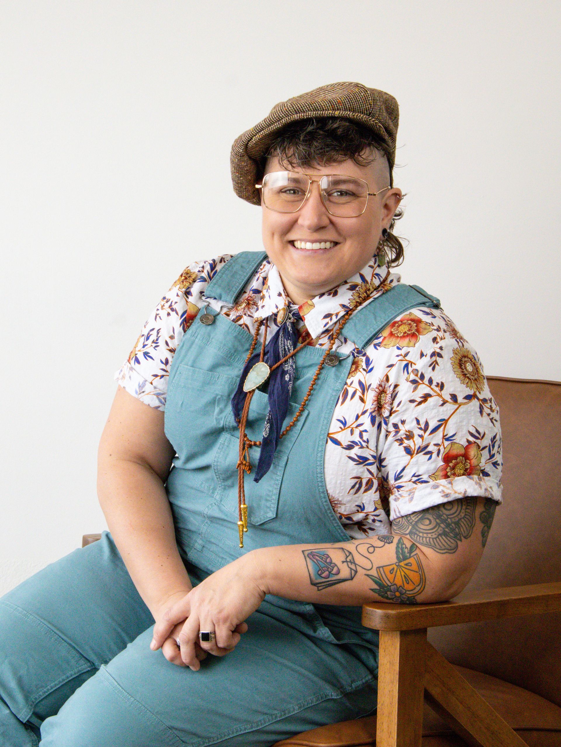 The front of a blue house with a porch and stairs.