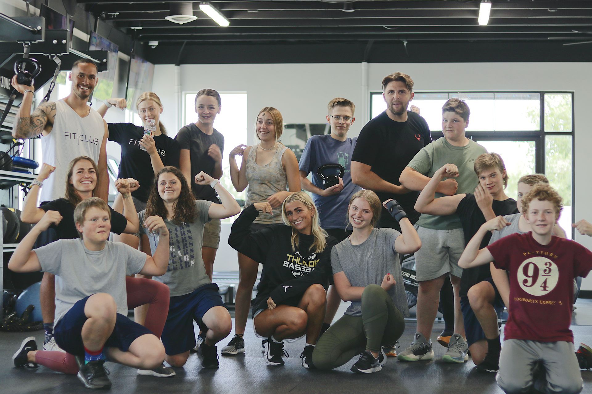 Teen fitness group at FitClub in Salem, Utah, posing after a strength training session.