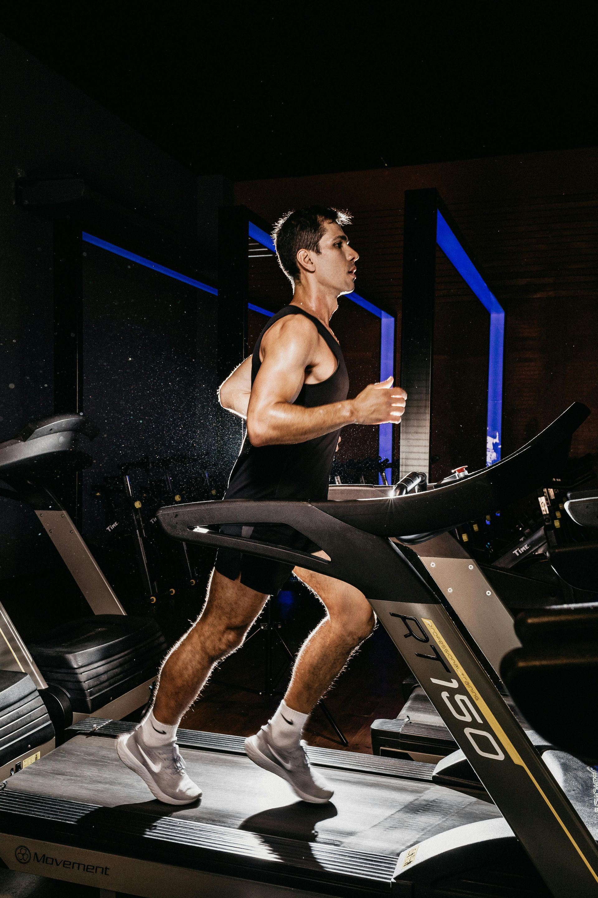 Man running on a treadmill at FitClub in Salem, Utah, for cardio training.