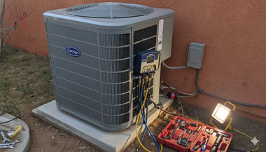 HVAC unit being serviced outdoors with tools and equipment.