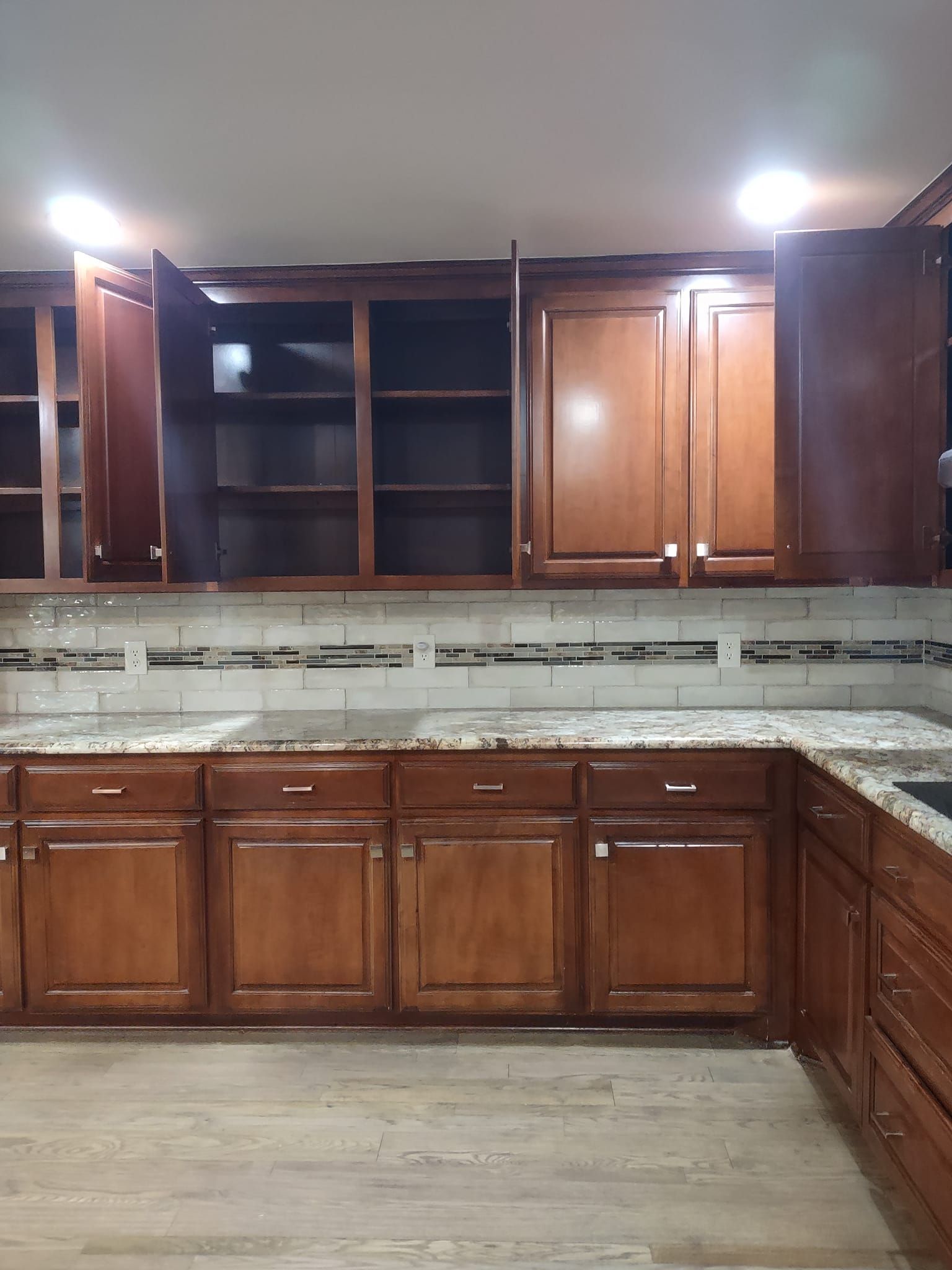 A kitchen with wooden cabinets and granite counter tops
