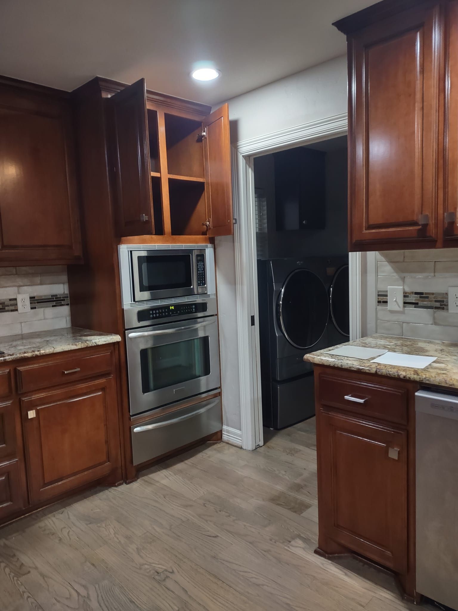 A kitchen with wooden cabinets and stainless steel appliances