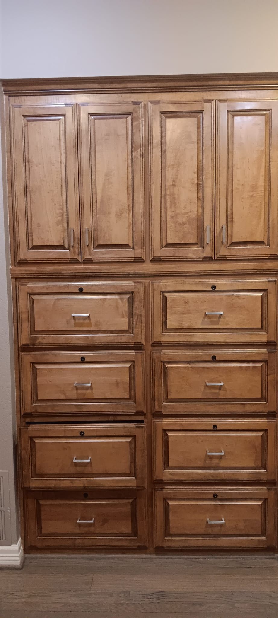 A closet with lots of drawers and cabinets in a room.