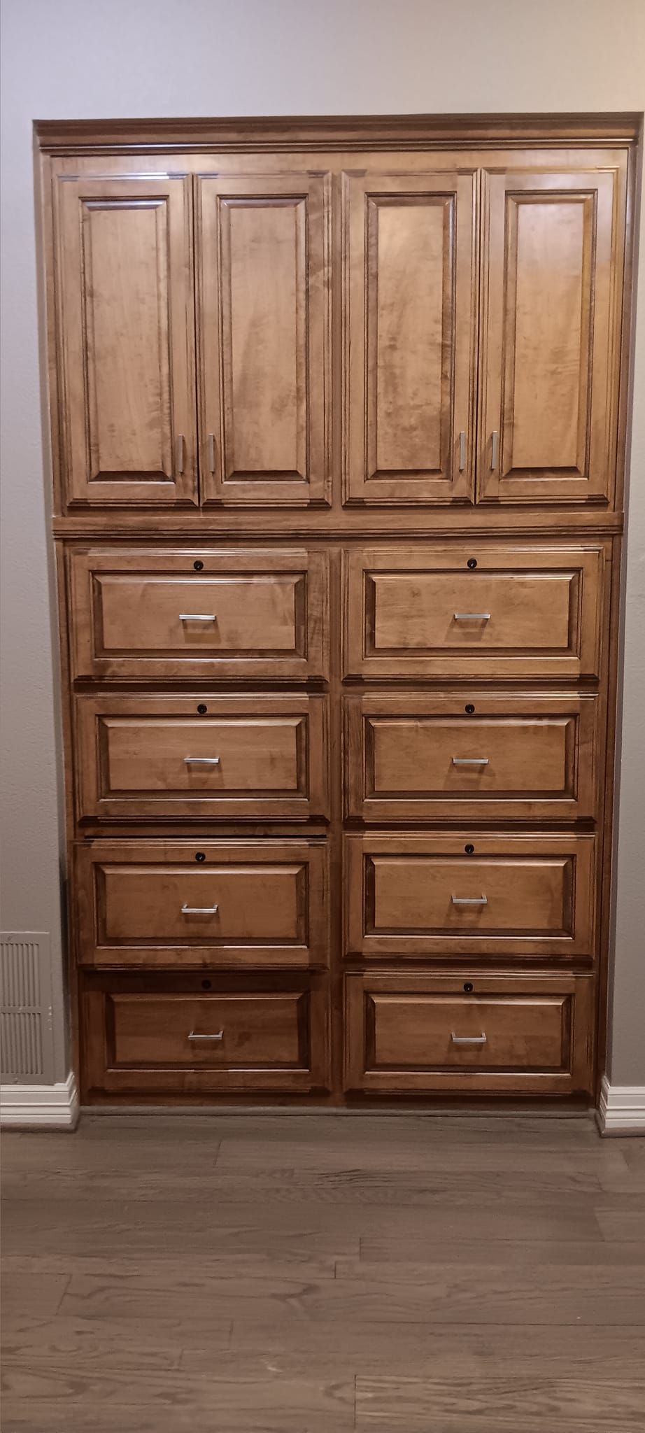 A closet with lots of drawers and cabinets in a room.