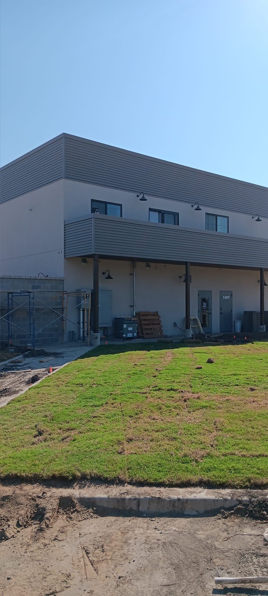 A large building with a lot of grass in front of it.