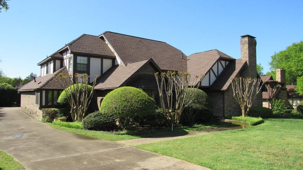 A large house with a driveway leading to it