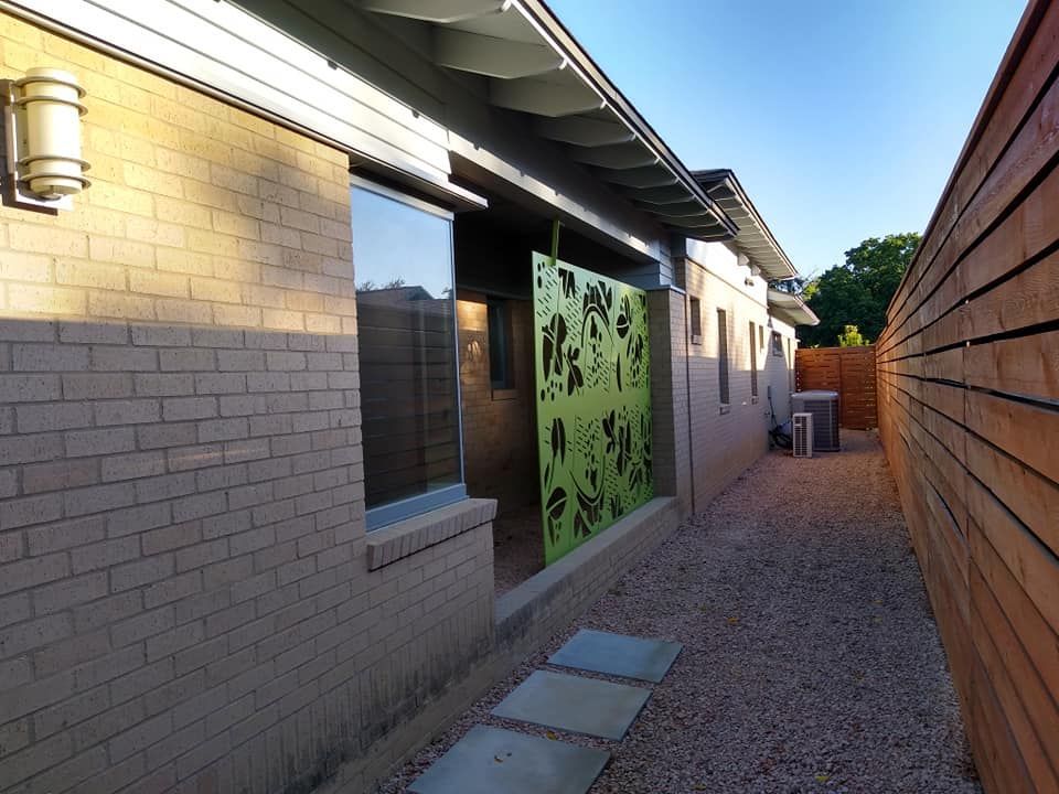 A brick house with a wooden fence behind it