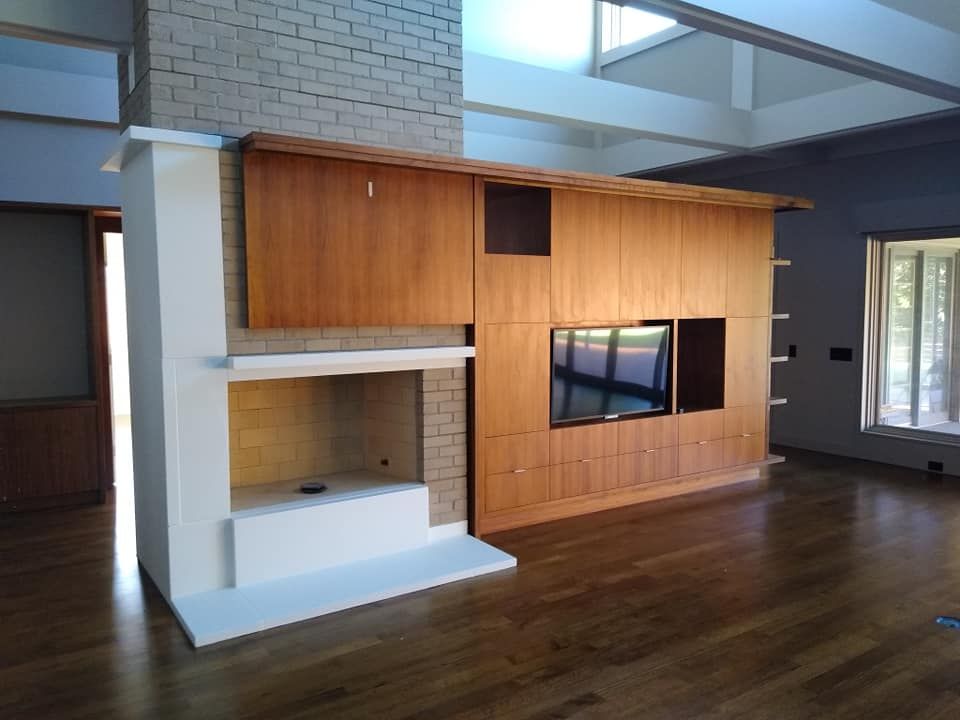 A living room with a fireplace and a flat screen tv