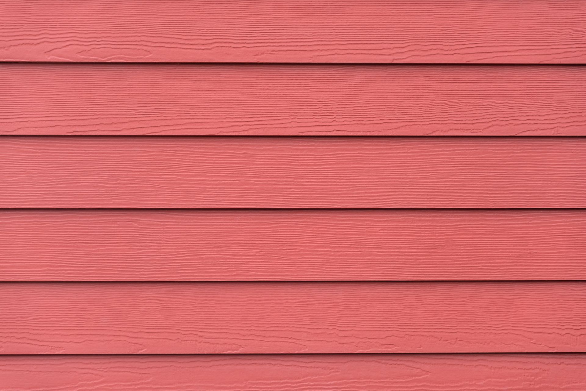 A close up of a red wooden wall with a seamless texture.