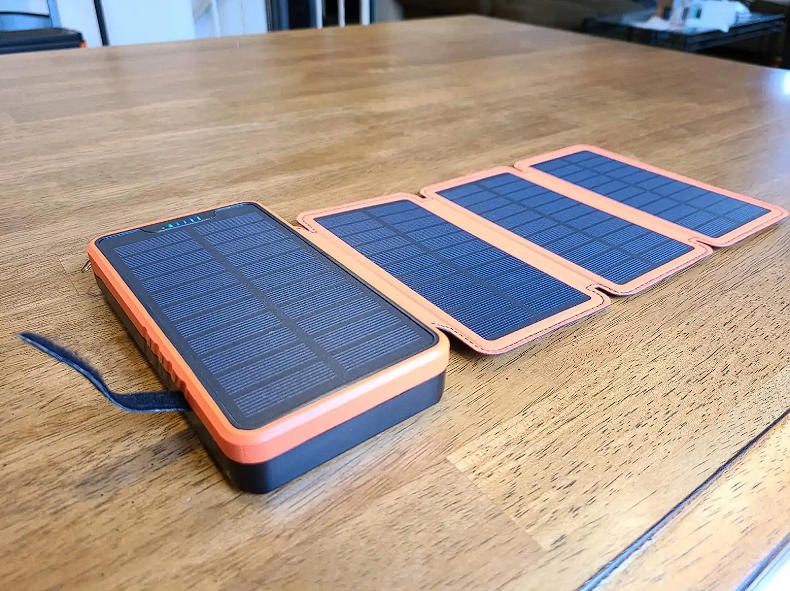 A solar charger is sitting on a wooden table