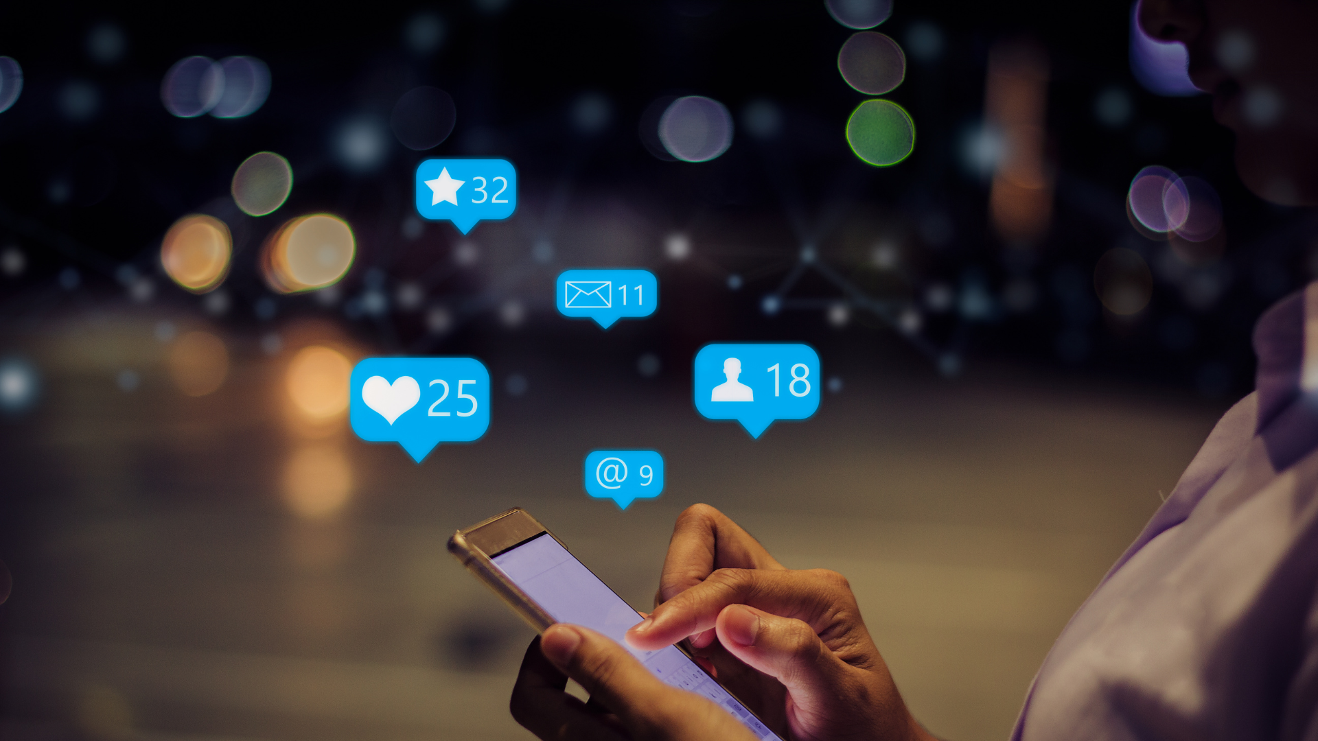 Social Media with a person is holding a cell phone in their hand.