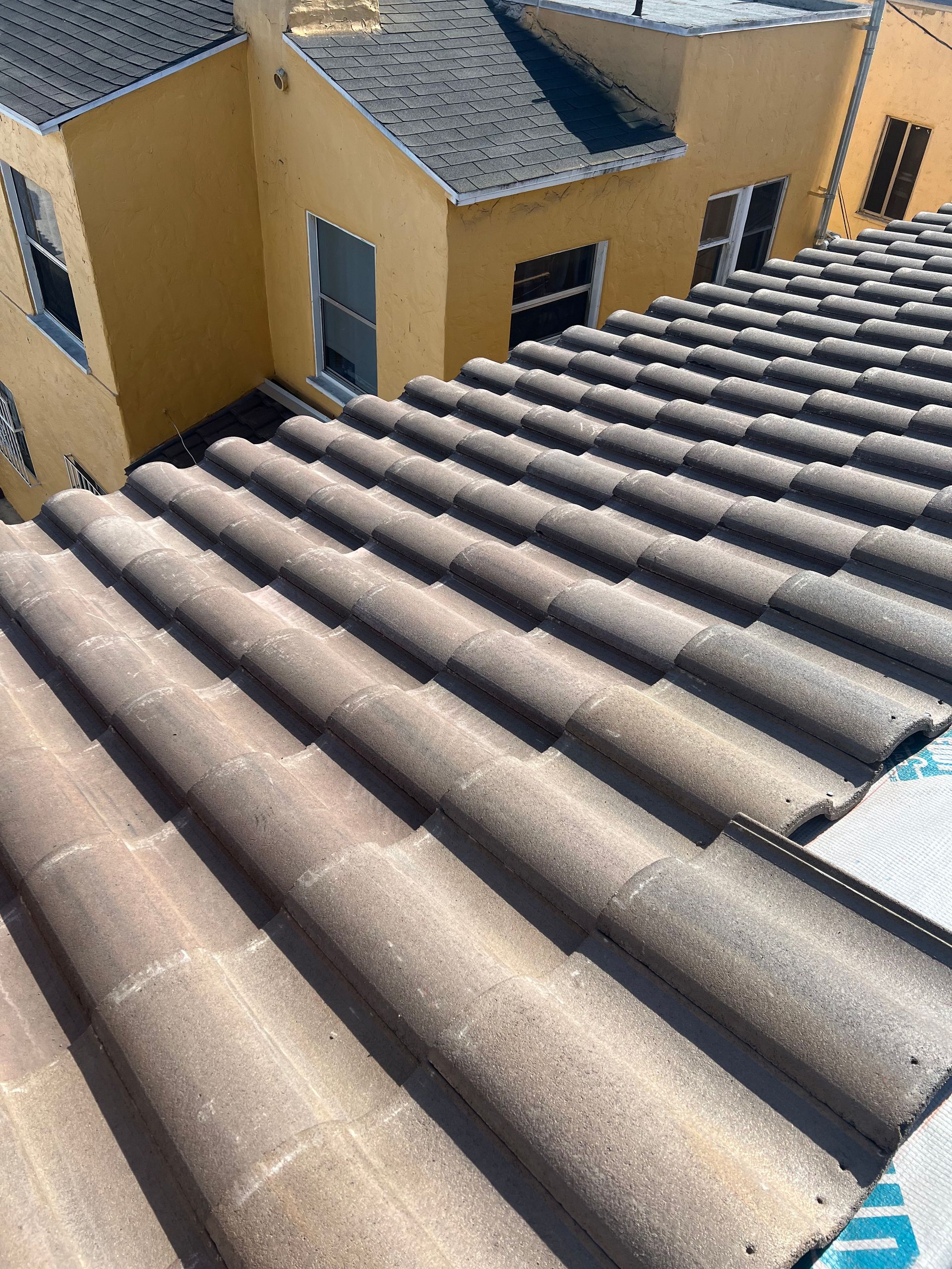 A man is working on the roof of a house