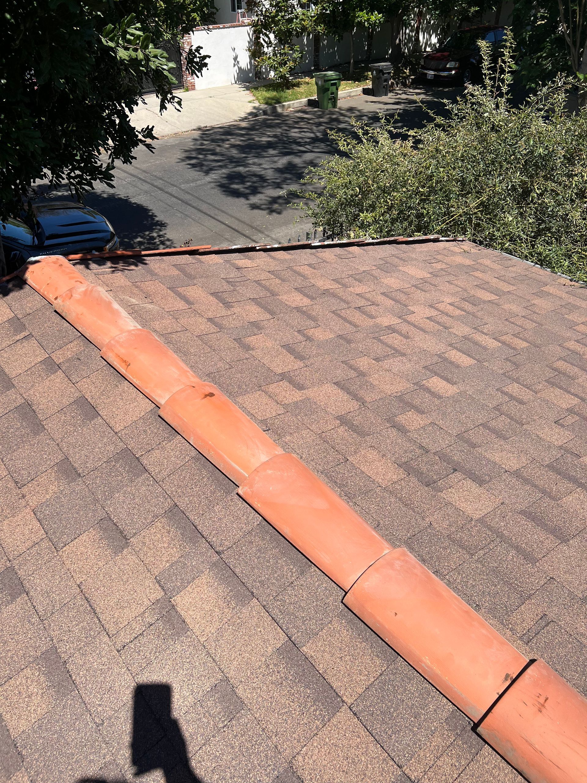 A metal roof is being installed on top of a wooden structure.