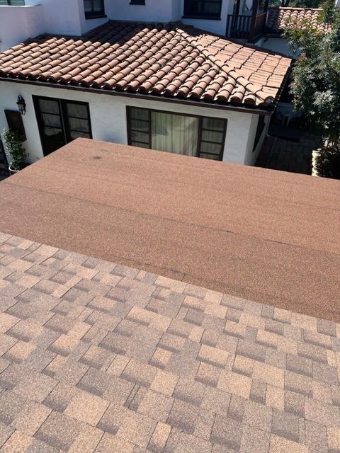 A group of construction workers are working on a roof.