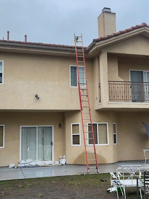 A house with a ladder on the side of it