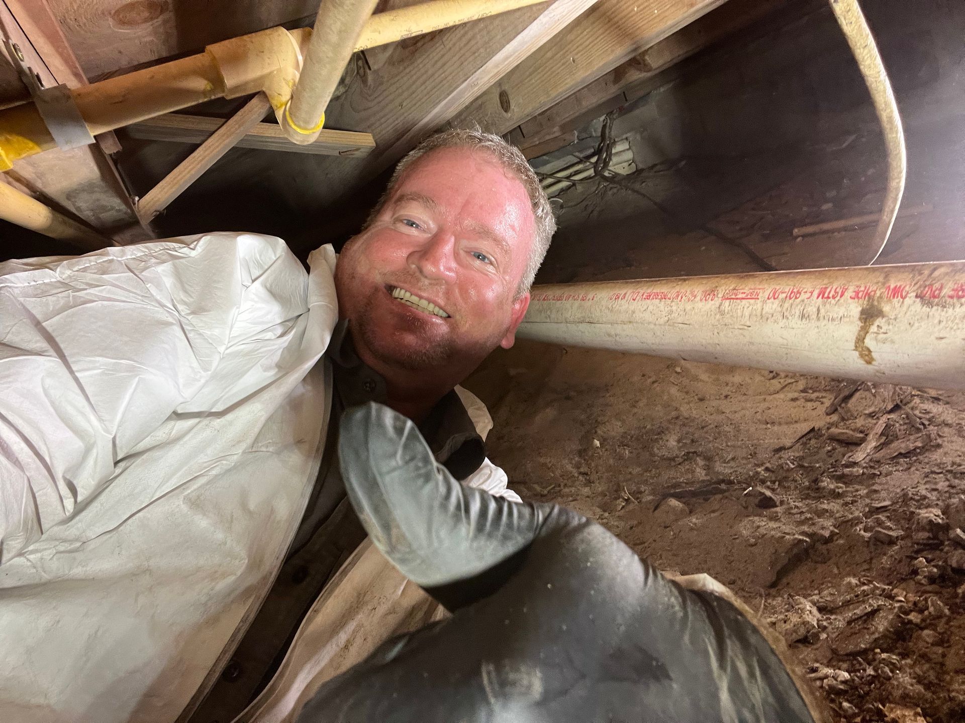 A bunch of pipes are hanging from the ceiling of a building