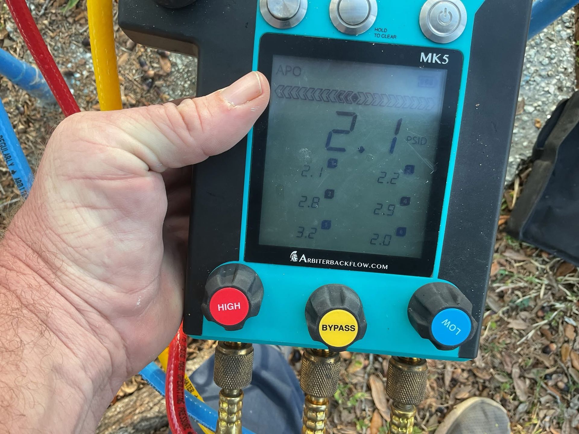A man is taking a picture of a pipe with a tablet.