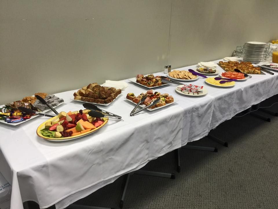 Table With a White Cloth is Set With Various Foods — Capricorn Motel & Conference Centre In Parkhurst, QLD