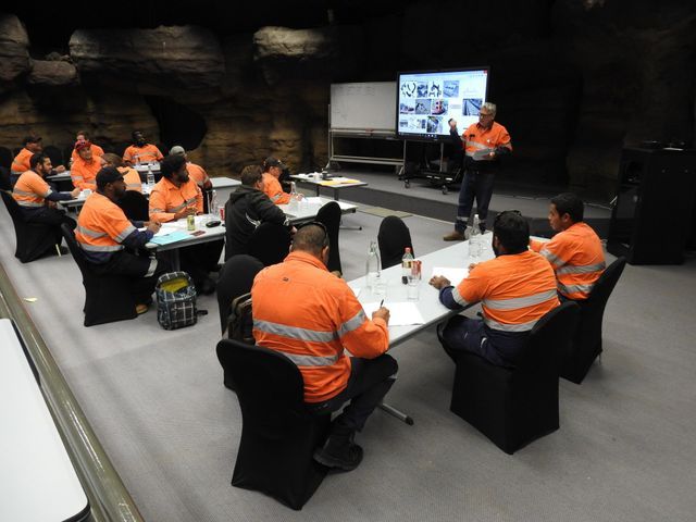 Group of People in Orange Workwear — Capricorn Motel & Conference Centre In Parkhurst, QLD