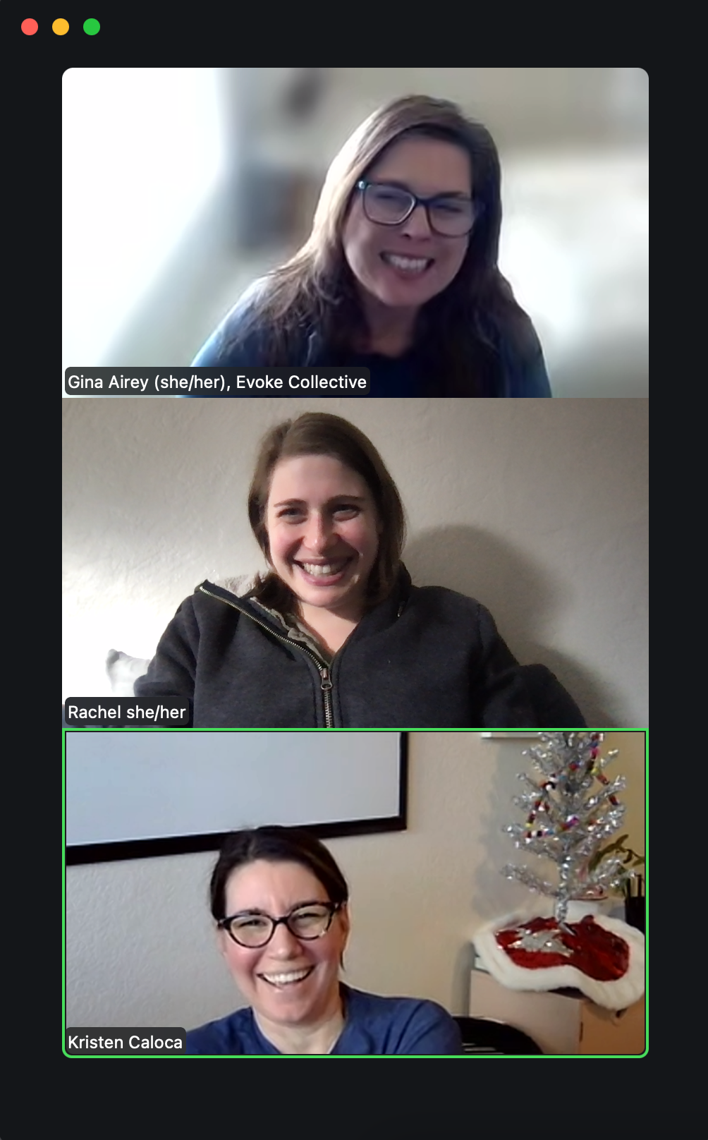 Three people on a video call smiling. The top person is wearing glasses. The bottom has a Christmas tree.