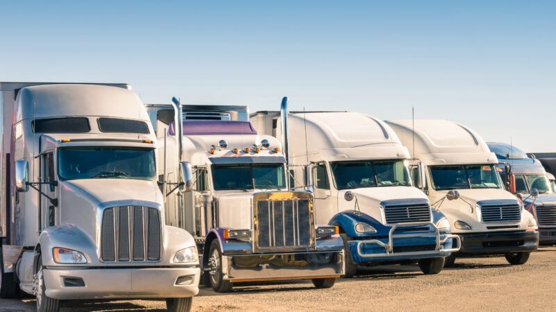 line of trucks are protected by trucking insurance