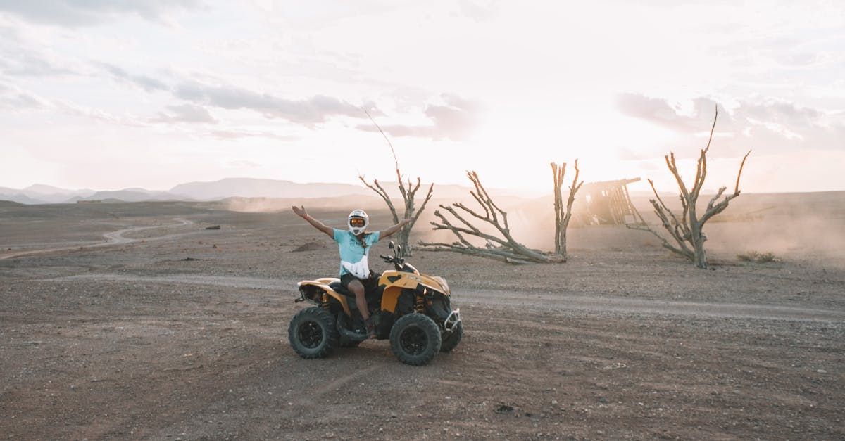 individual rides an ATV in the distance