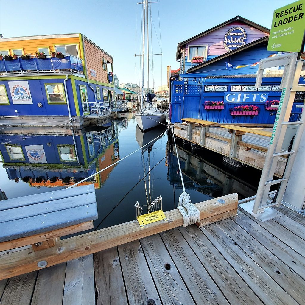 A dock with boats and a sign that says rescue ladder