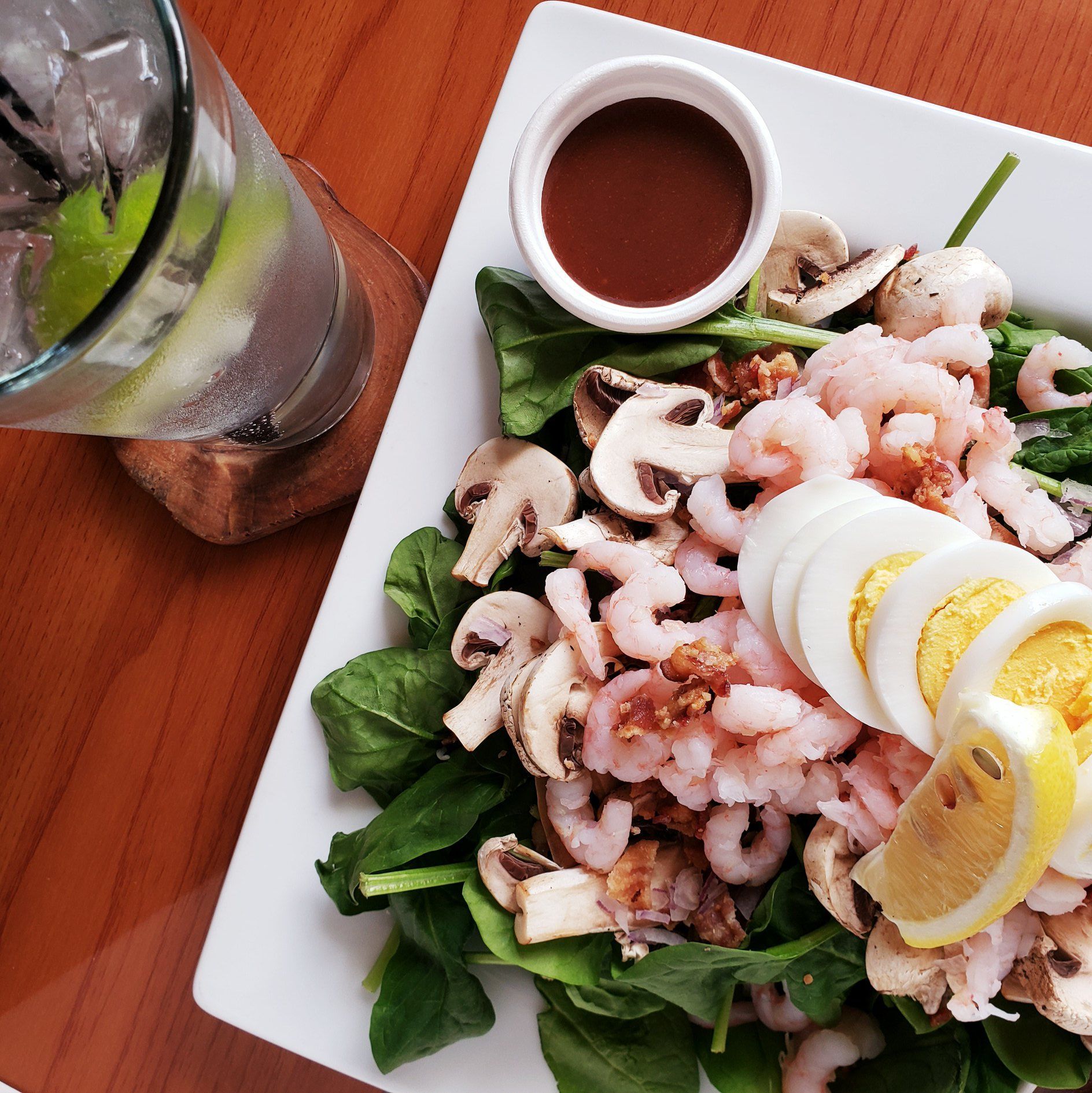 A plate of food next to a glass of water