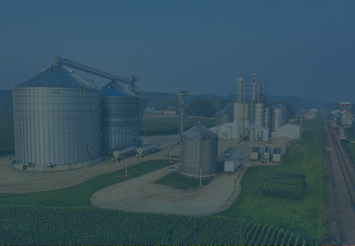 Grain silos and processing facility in a rural setting.