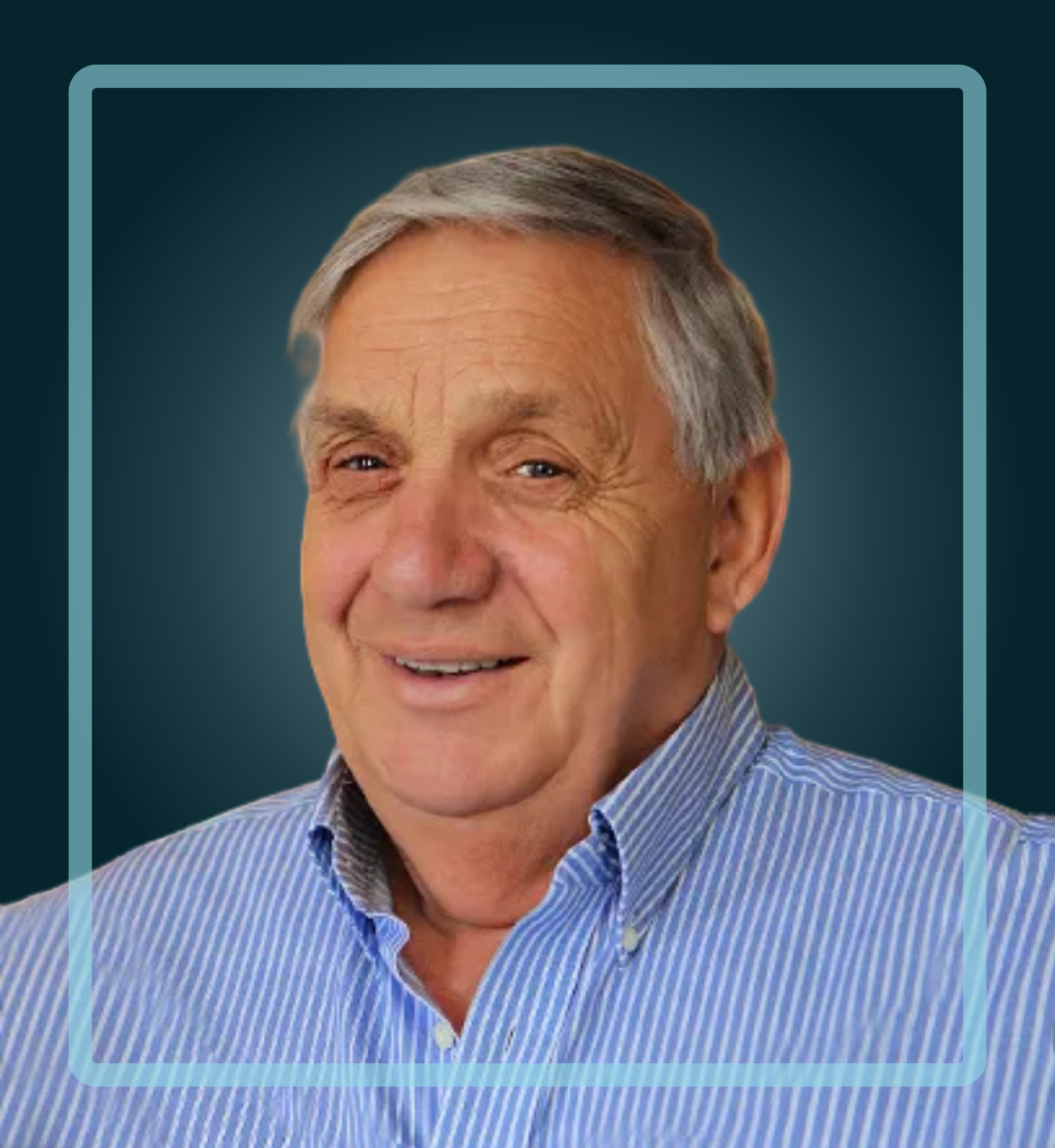Smiling older man wearing a blue striped shirt; set against a dark teal background with a light blue square outline.
