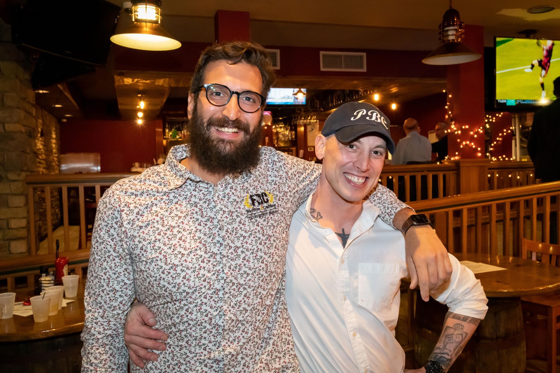Two men are posing for a picture together in a restaurant