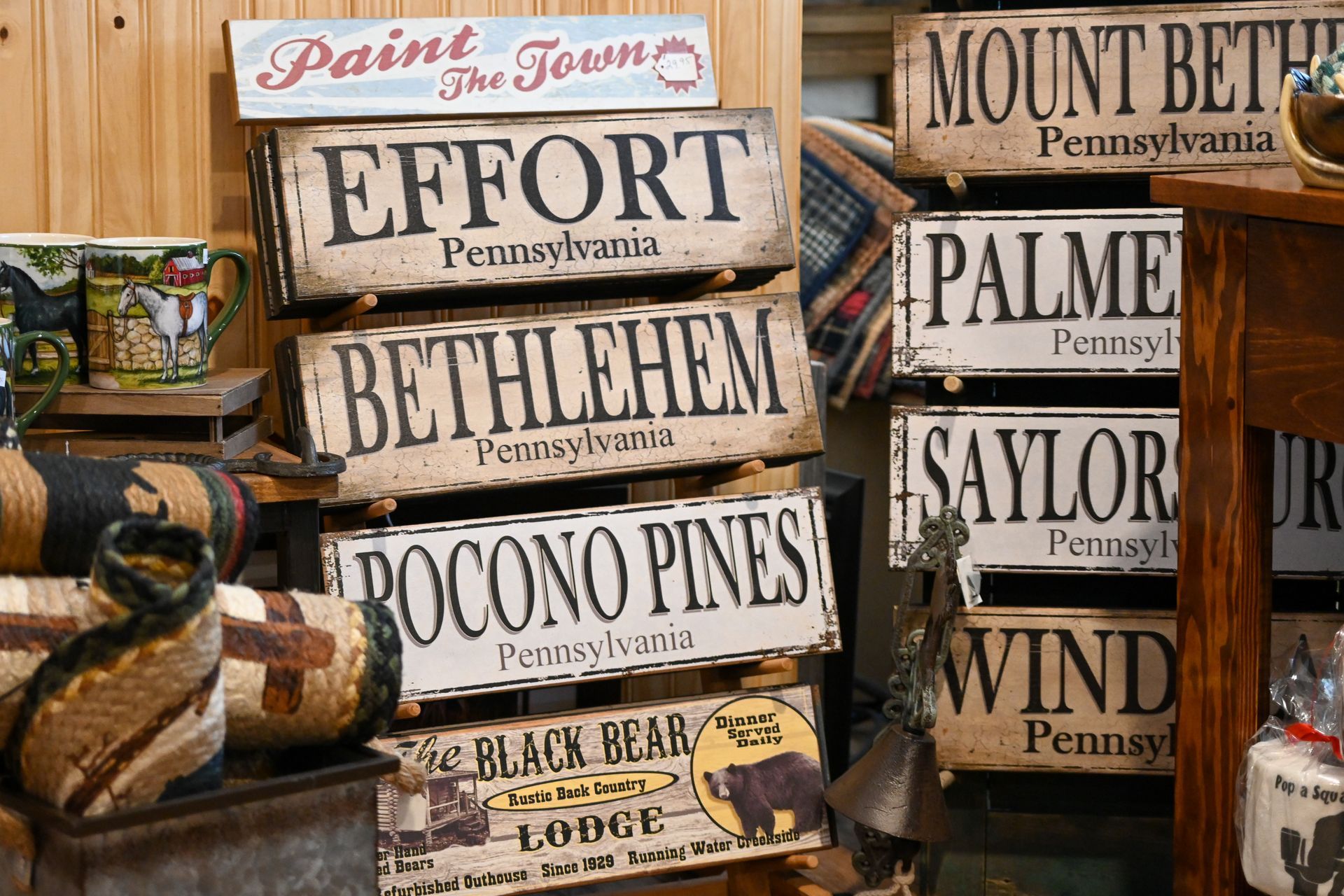 A bunch of wooden signs are stacked on top of each other.