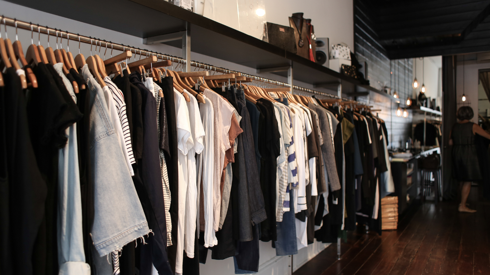 A store filled with lots of clothes hanging on racks