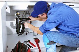 handyman fixing kitchen sink