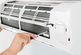 contractor repairing an air conditioner