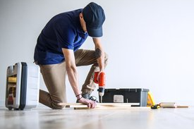 contractor repairing a home flooring