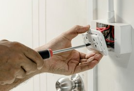 handyman repairing an electrical switch