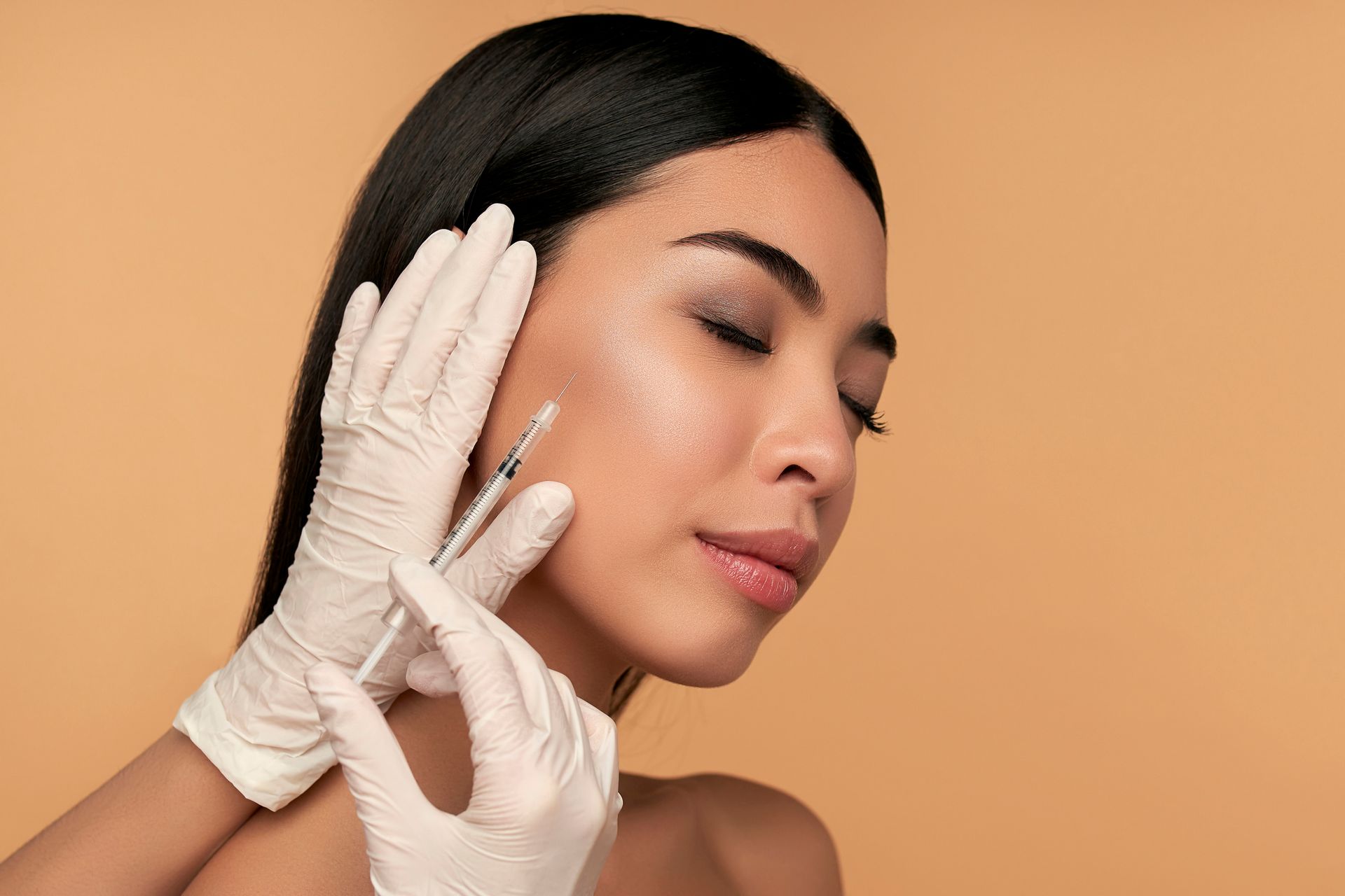 Woman receiving dermal filler injection in Johnson City TN for youthful skin enhancement.