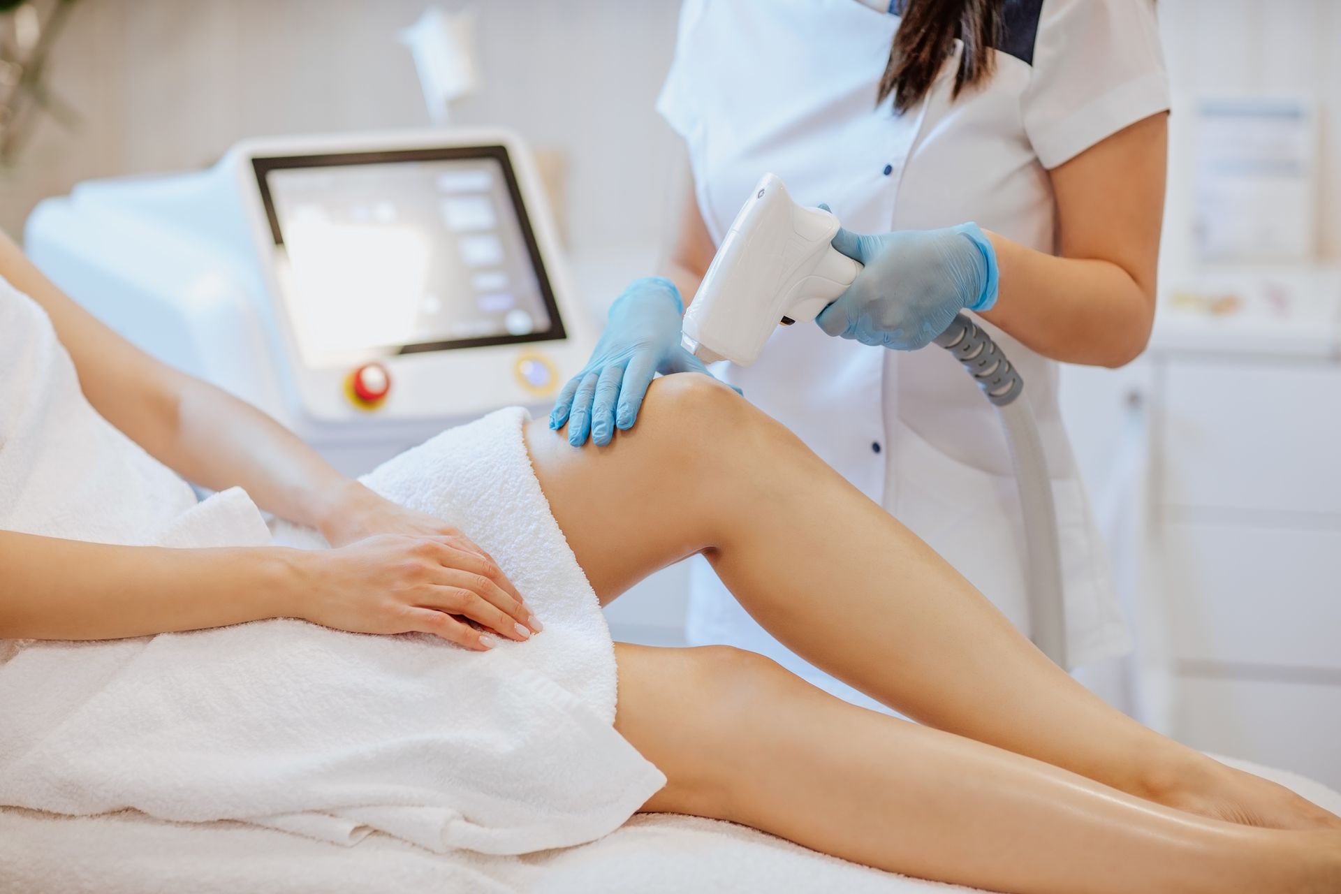 Laser technician treating a patient’s lower leg with precision.