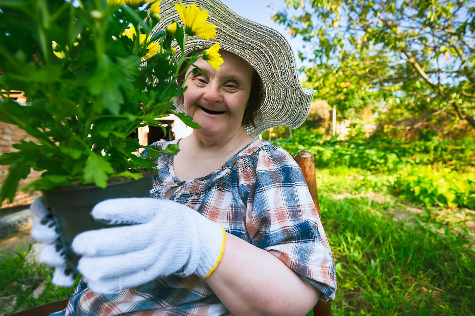 Happy woman ready to plant flowers.
